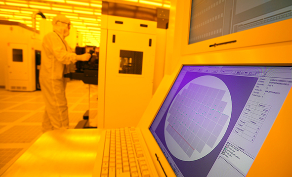 view of computer and worker inside of the cleanroom