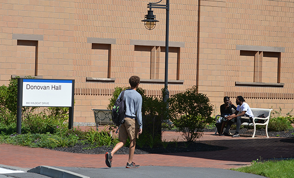 student walking in front of Donovon Hall