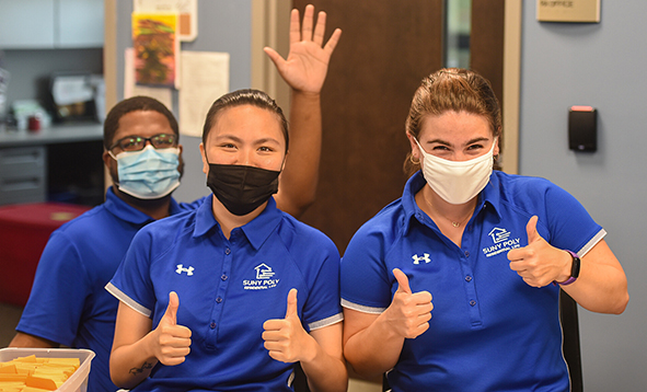 res life staff with masks giving thumbs up