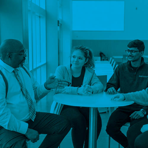 three friends chatting at a table with blue overlay