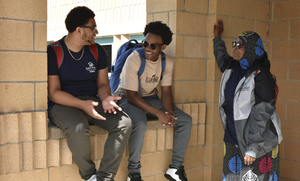 three students waiting for class to start