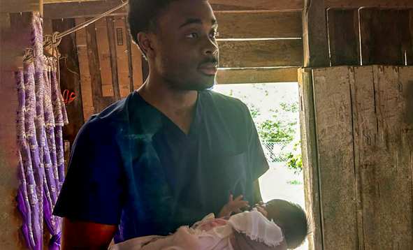 medical student holding small child